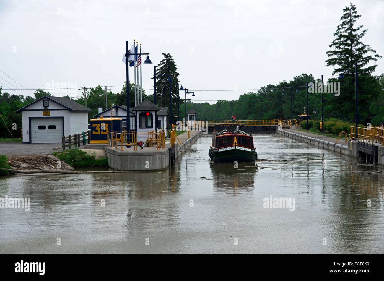 Charter boat exits from lock after ascending from a lower level. Stock Photo