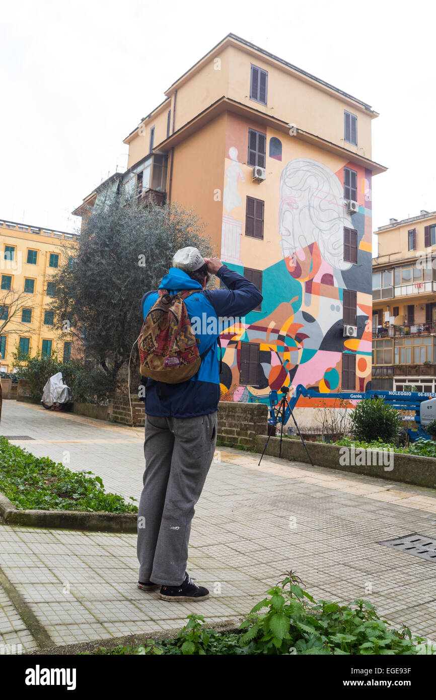 Worldwide famous urban artist Reka (Australia, 36) painting a wall in Tor Marancia, Rome, Italy, for the next opening of an open air art museum Stock Photo