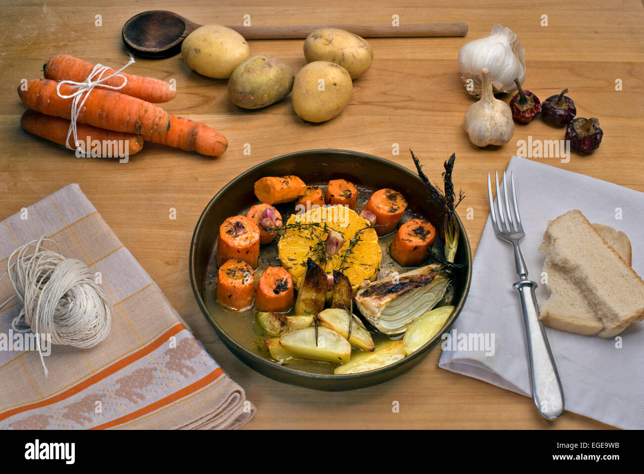 Carrots roasted in white wine with oranges, garlic, fresh thyme and butter served with rosemary roasted potatoes and fennel Stock Photo