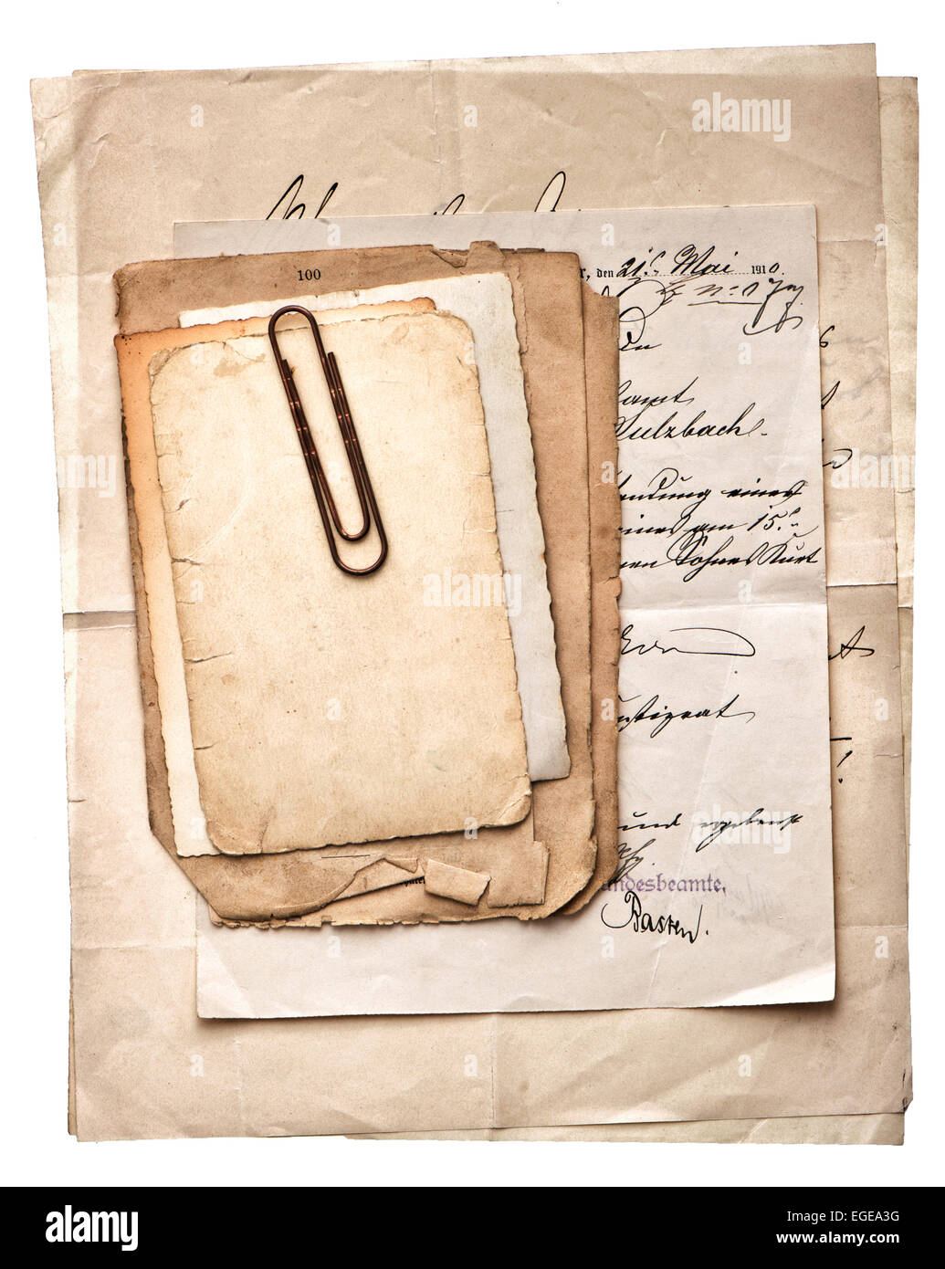 pile of old vintage papers, postcards and letters with paper clip on white background Stock Photo