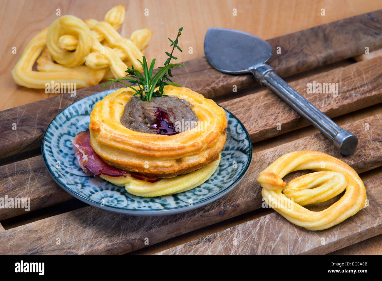 Meat terrine in choux pastry nest with prosciutto, herbs and cranberry
