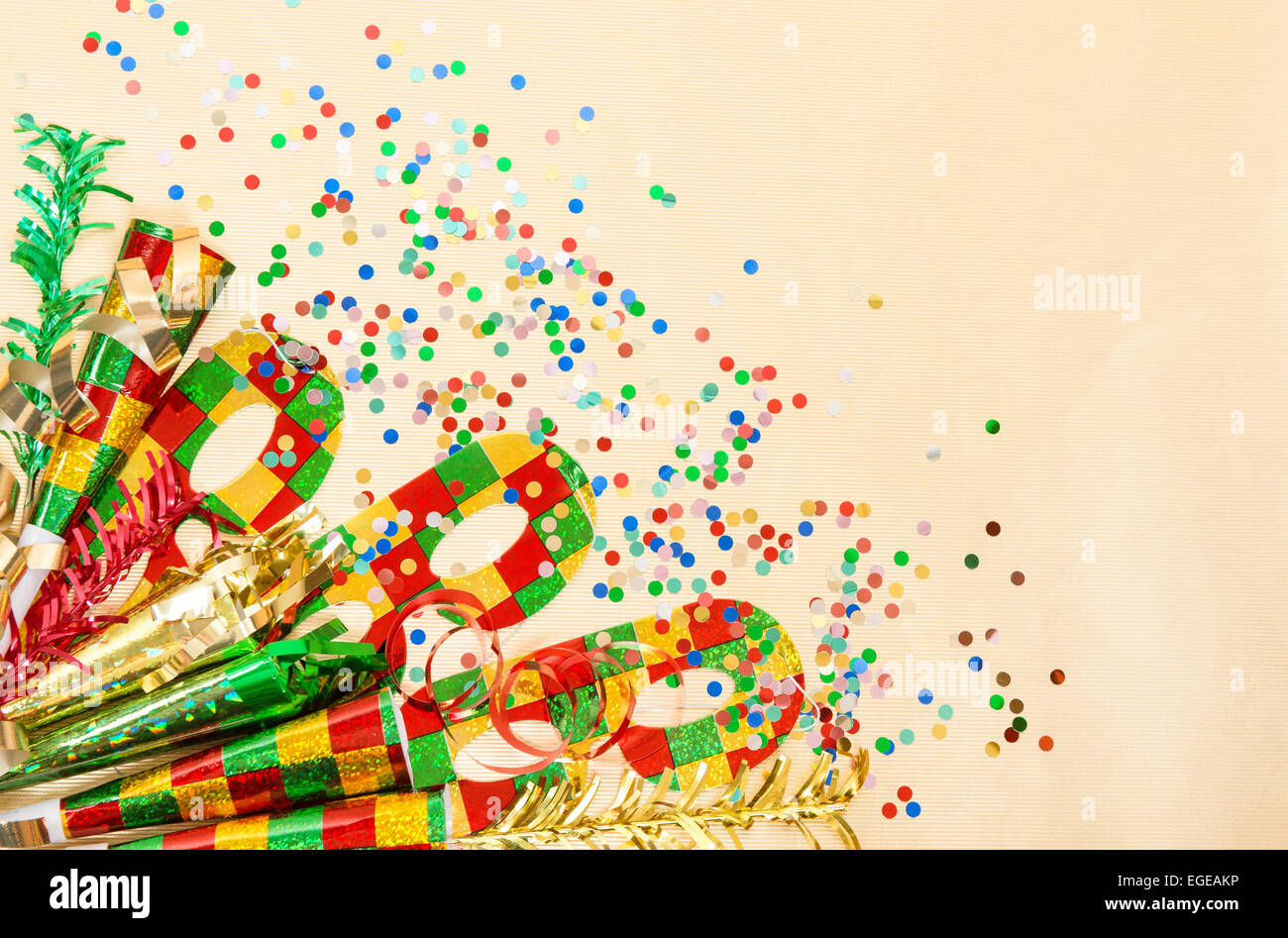 Carnival mask, confetti, streamer. Holidays decorations over golden background Stock Photo