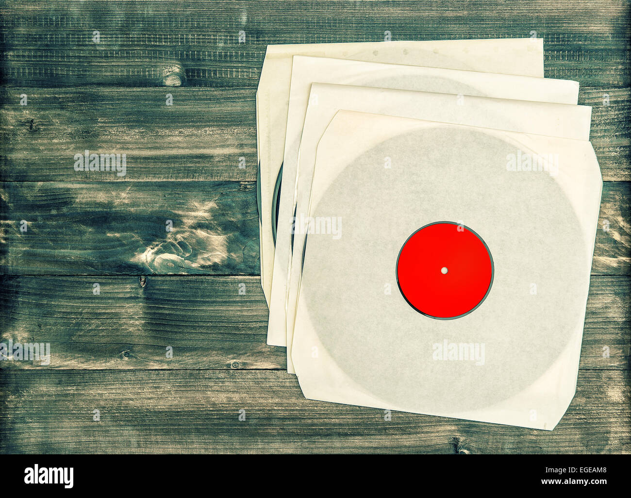 vintage vinyl records on rustic wooden background. nostalgic retro objects Stock Photo