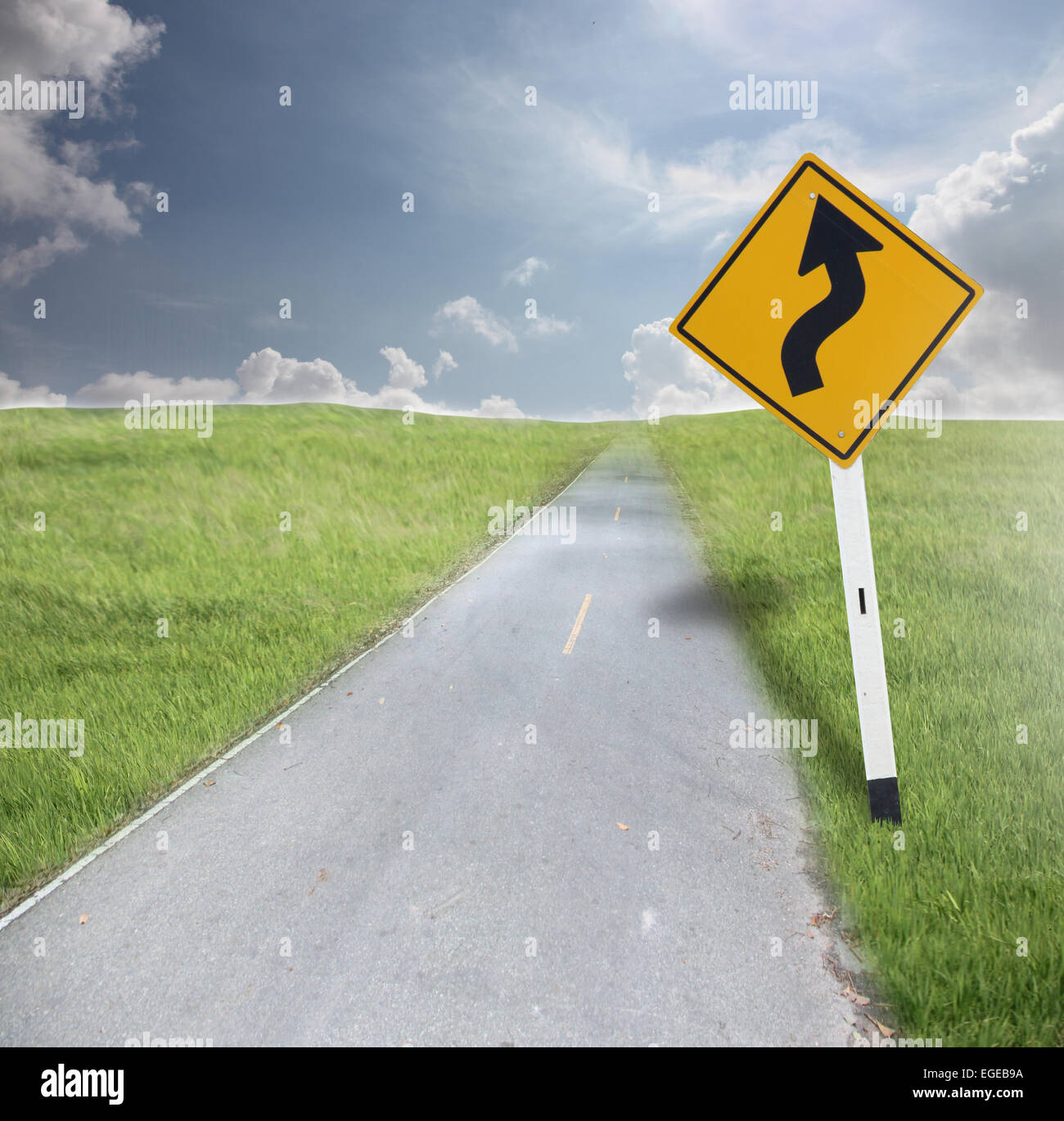 Traffic signs and road on the wide meadow. Stock Photo