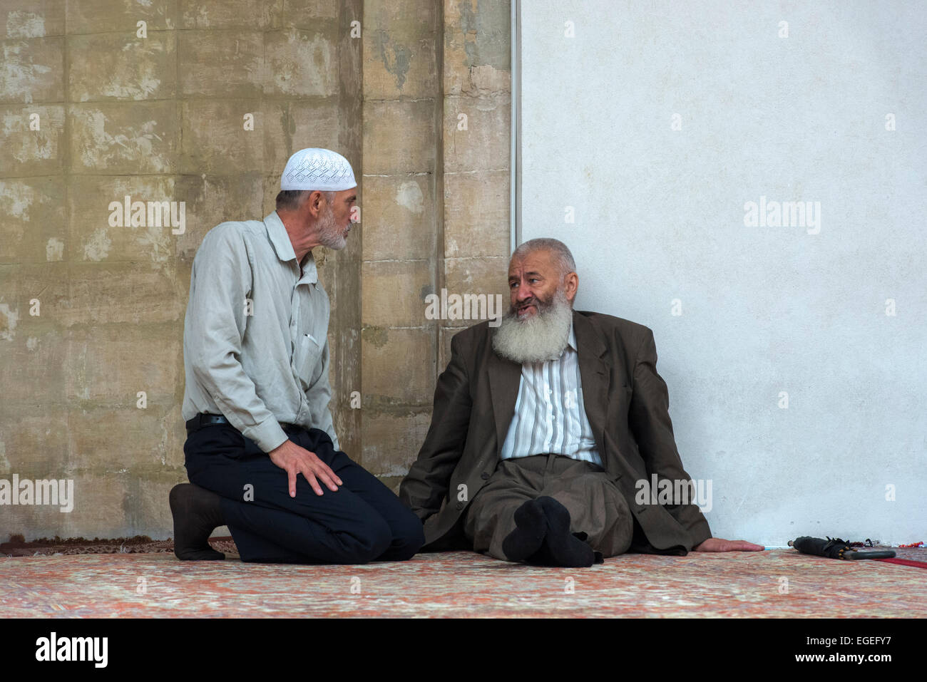 Old Bosniak Muslim Men Chatting In Front Of The Mihrab, Gazi Husrev Begova Mosque, Sarajevo Stock Photo