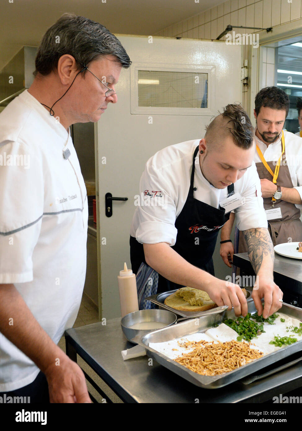 Baiersbronn, Germany. 23rd Feb, 2015. Three-star chef Harald Wohlfahrt (L-R) watches chefs Crone-Rawe and Christian Geisler in the kitchen of the restaurant Traube-Tonbach during CookTank in Baiersbronn, Germany, 23 February 2015. CookTank considers itself a sort of cooking and think tank, in which top chefs, media representatives, producers, and experts develop ideas and strategies for tomorrow's cuisine. Photo: Thomas Kienzle/dpa/Alamy Live News Stock Photo
