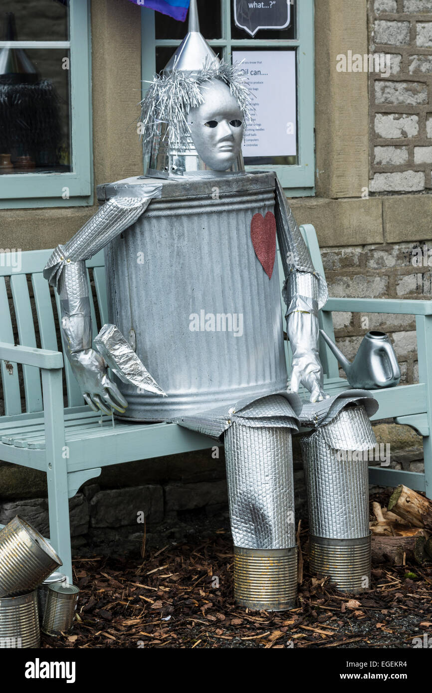Tin man character sitting on bench  at carnival held in Tideswell in the Peak District Derbyshire England Stock Photo