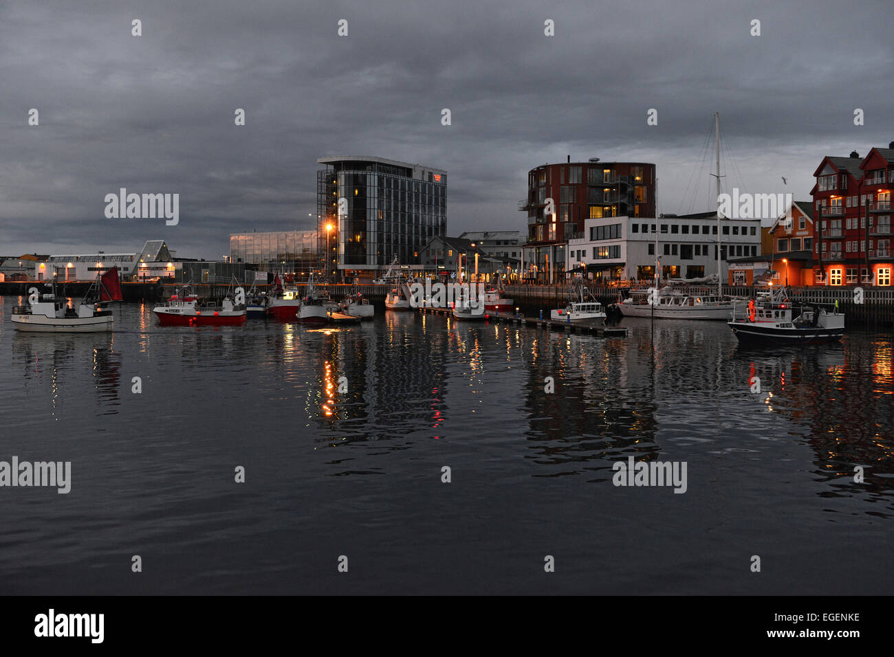 Harbour basin with boats and hotel buildings on the shore at twilight, Svolvær, Lofoten, Nordland, Norway Stock Photo