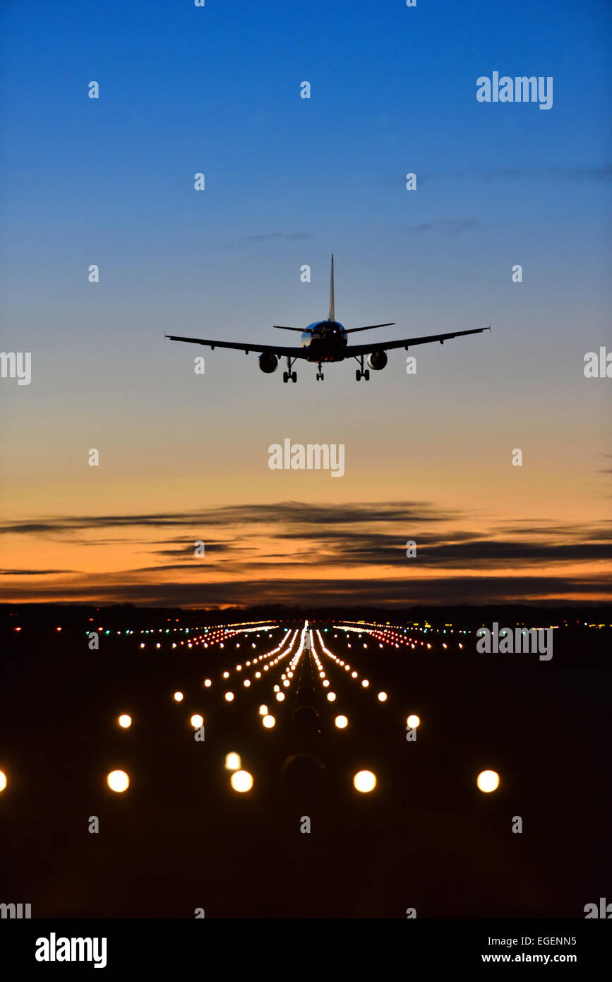 Aircraft landing at sunset, Airbus, runway, landing lights, Munich Airport 'Franz Josef Strauss', Munich, Upper Bavaria, Bavaria Stock Photo
