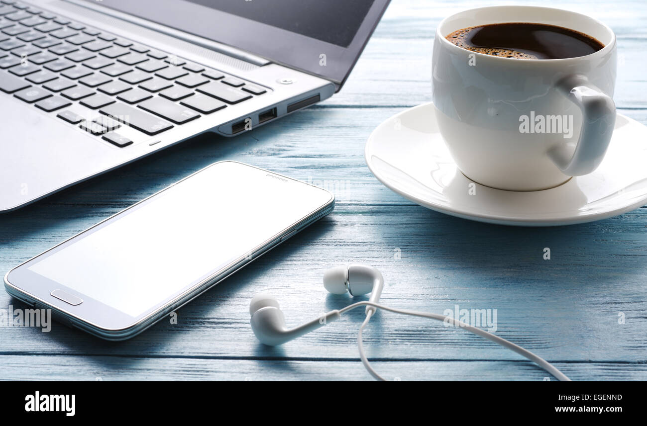 Coffee break. Office table with different gadgets on it. Top view. Stock Photo