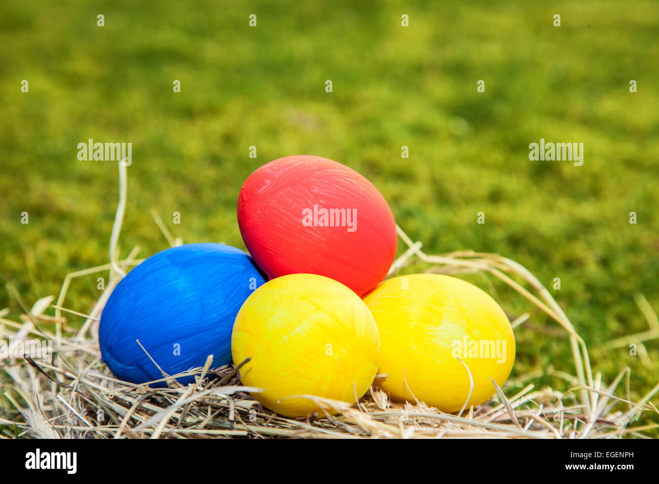 Easter eggs lying in straw Stock Photo - Alamy