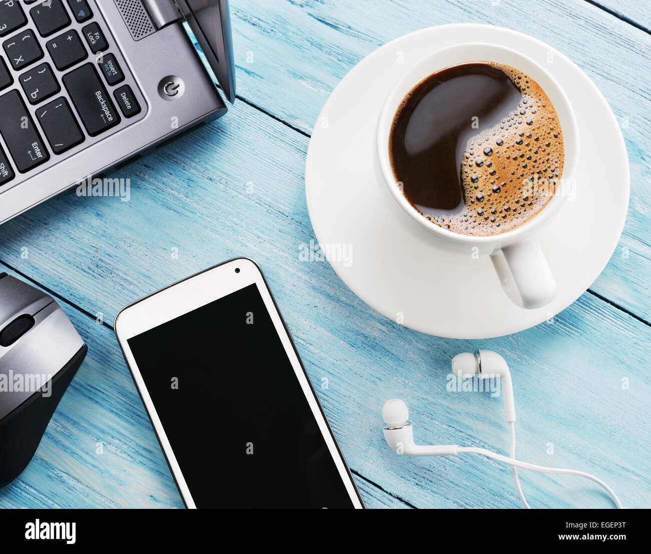 Coffee break. Office table with different gadgets on it. Top view. Stock Photo