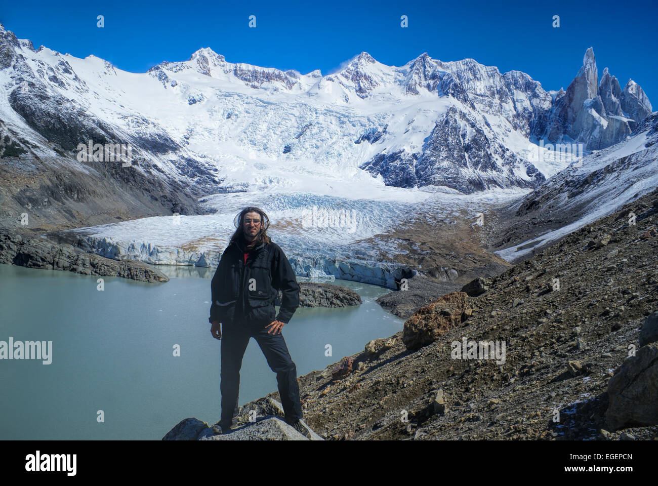 Hiker standing on the shore in Los Glaciares National Park Stock Photo ...