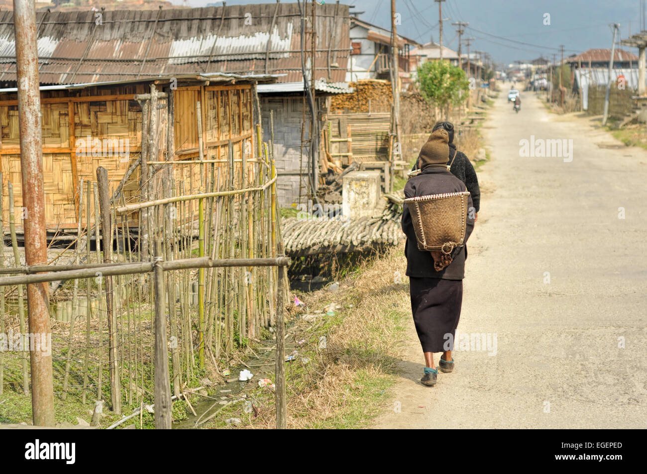 People walking along the street in a poor quarter in Arunachal Pradesh, India Stock Photo