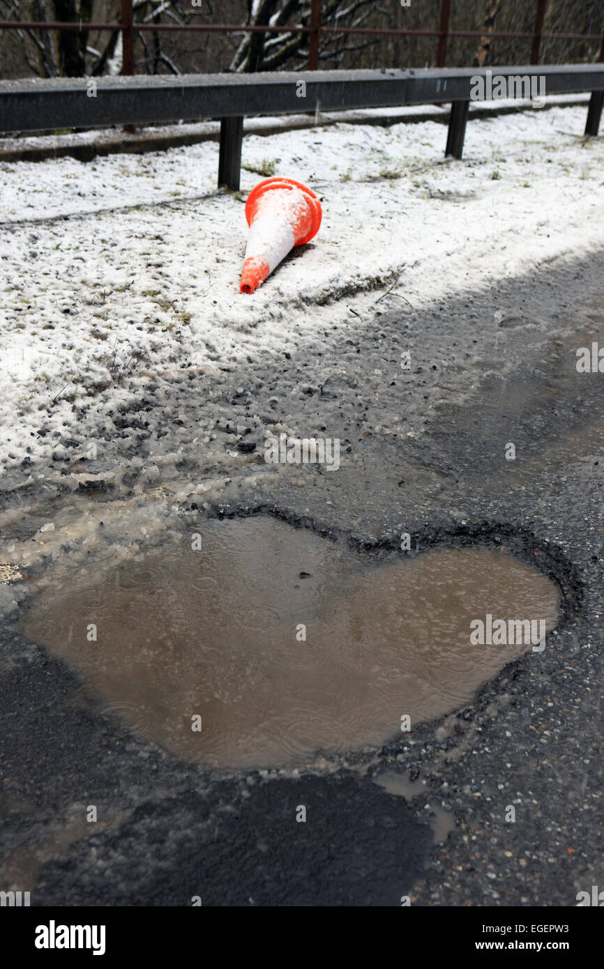 Deep potholes on Scotland's roads Stock Photo