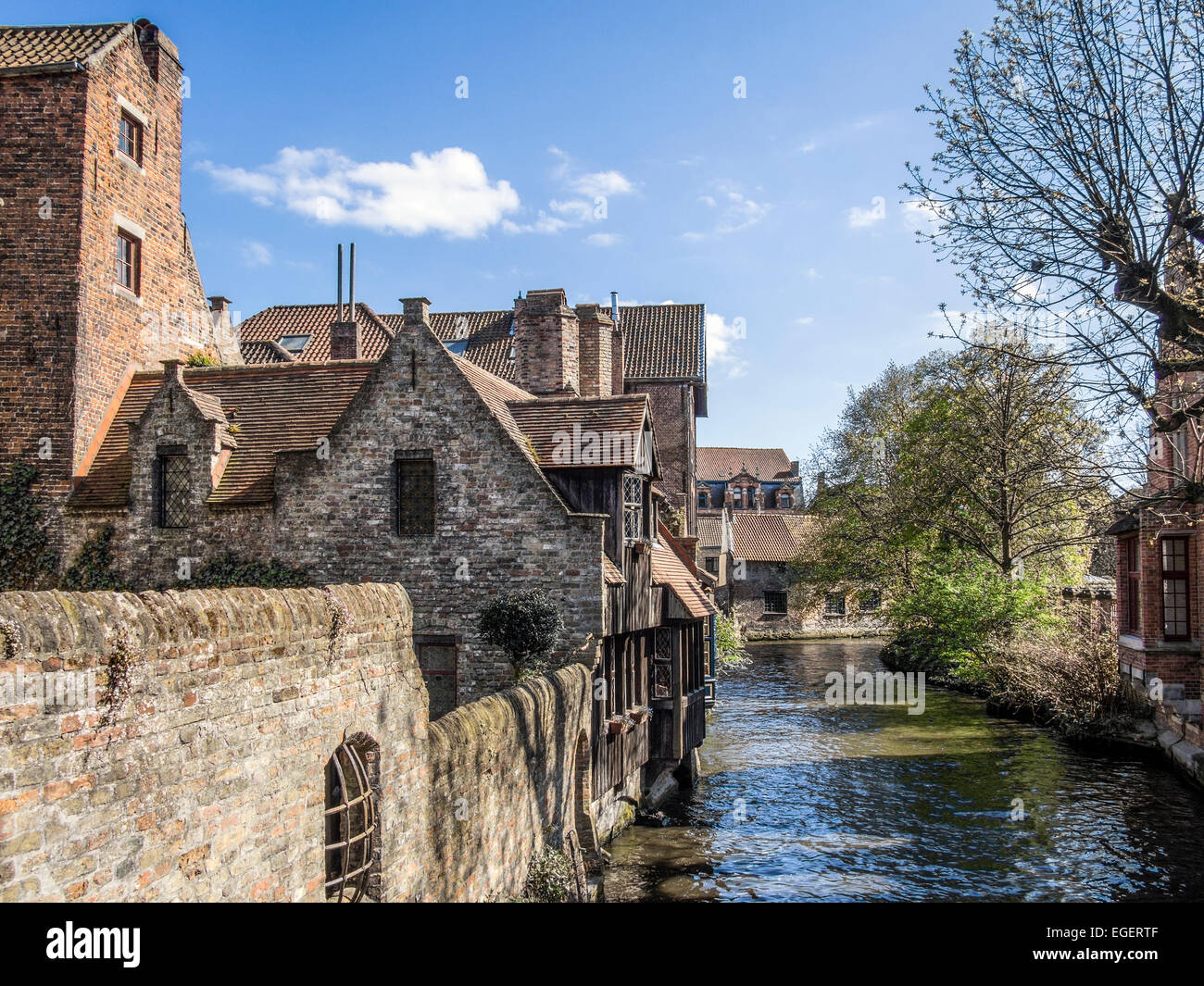 BRUGES, BELGIUM, UK - APRIL 13, 2014:  Exterior view of 17C Houses along one of the canals in the city Stock Photo