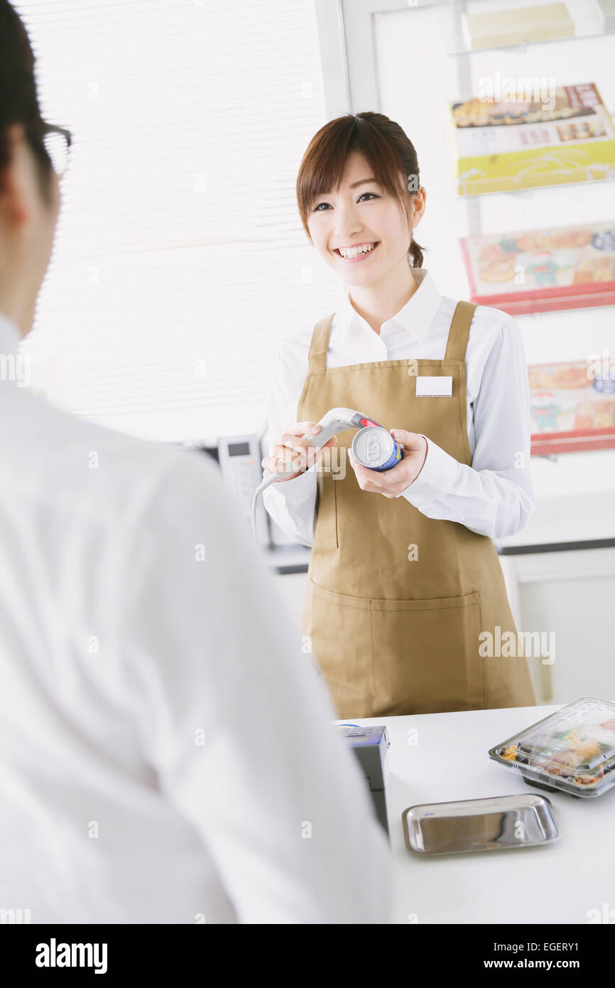 Young Japanese woman working at convenience store Stock Photo - Alamy