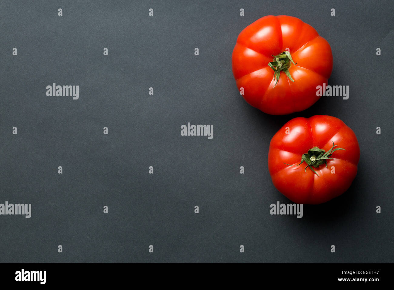 the red tomatoes on black background Stock Photo - Alamy
