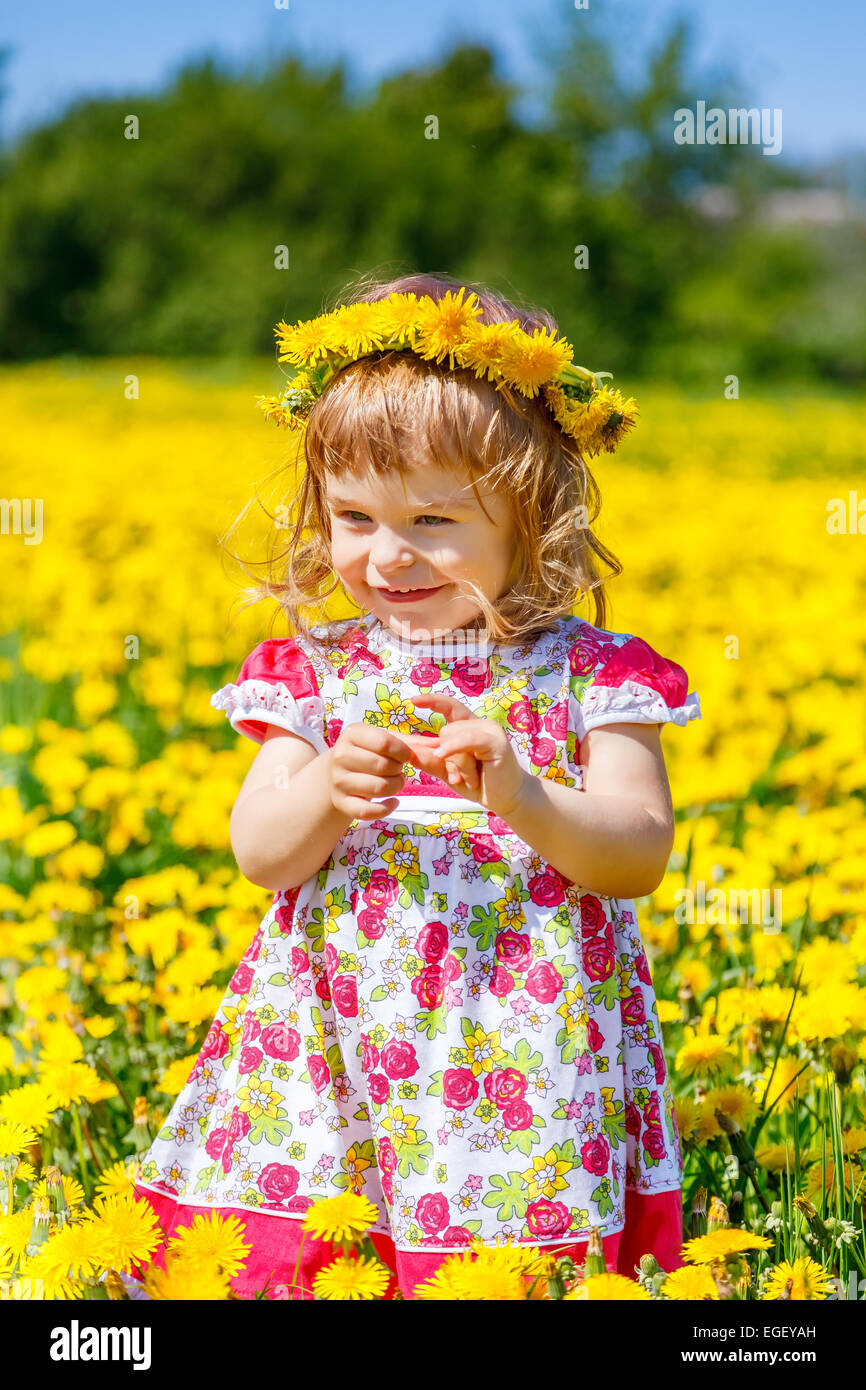 Little girl on the dandelion field Stock Photo - Alamy