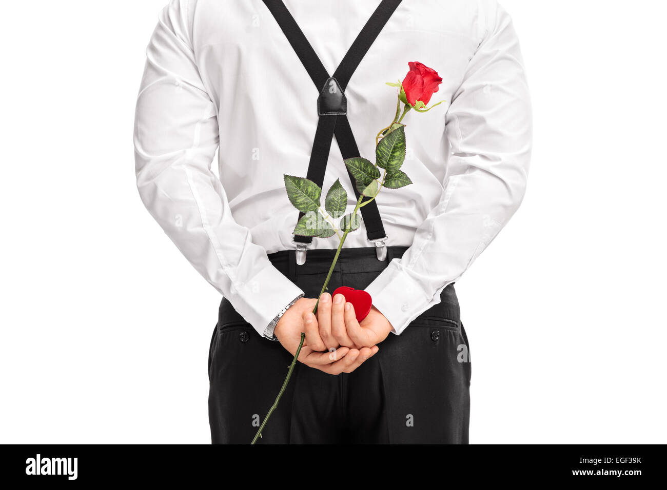 Close-up on a man holding flower and a red box behind his back isolated on white background Stock Photo