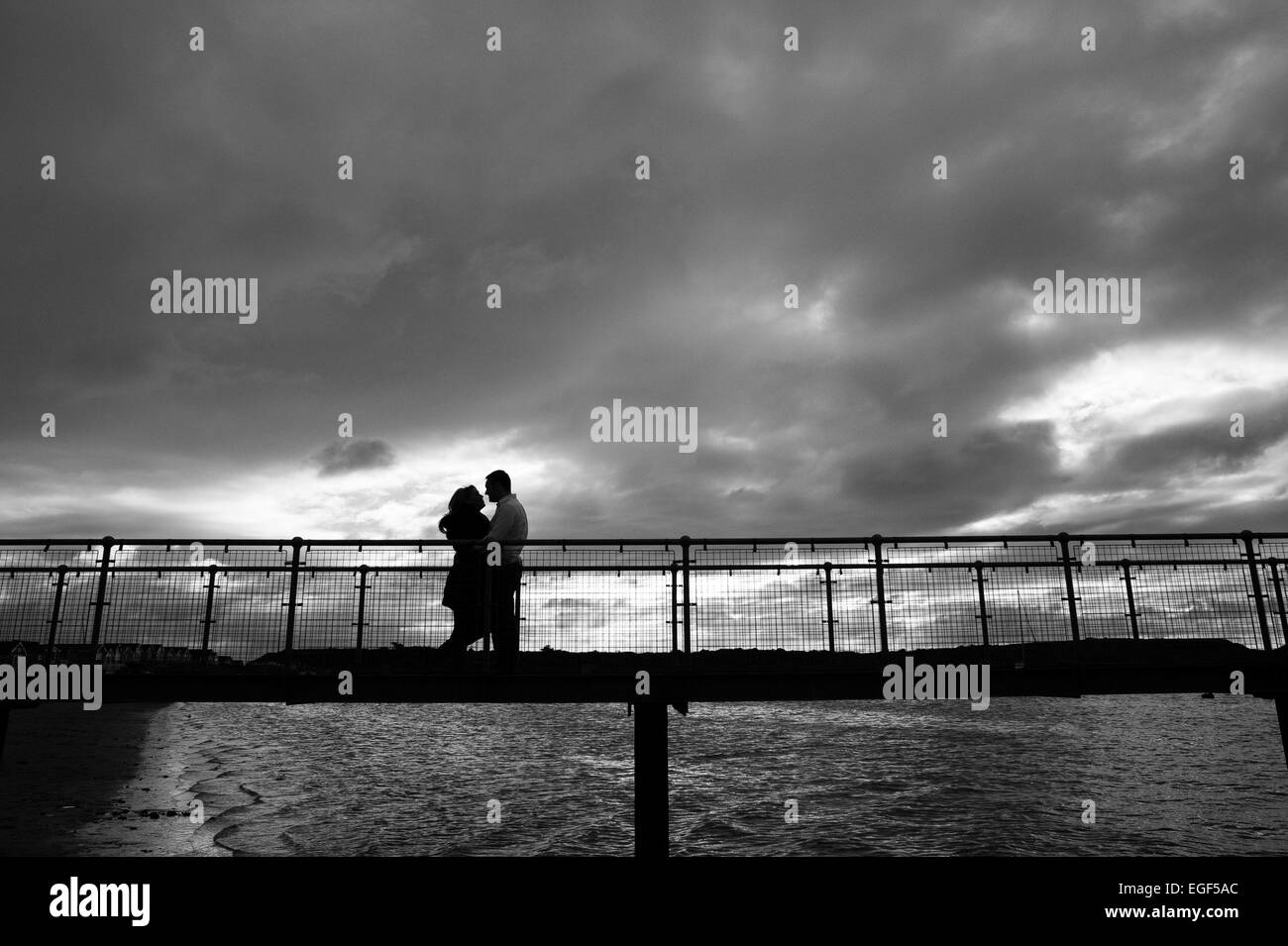 A couple embrace on a bridge Stock Photo