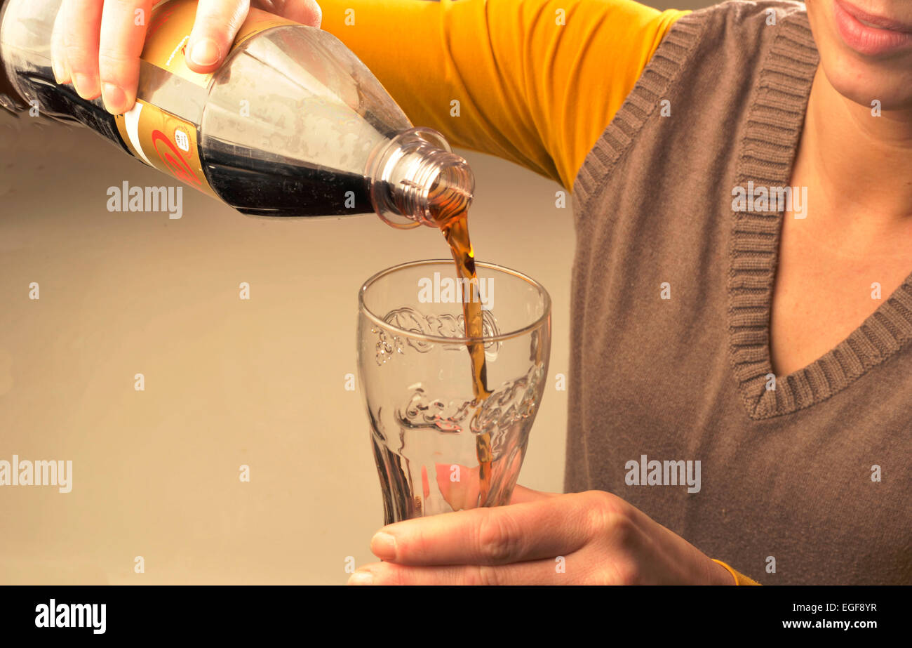 Symbol photo about sugar in foods and beverages: Woman drinking Coca-Cola.  Photo: Klaus Rose Stock Photo