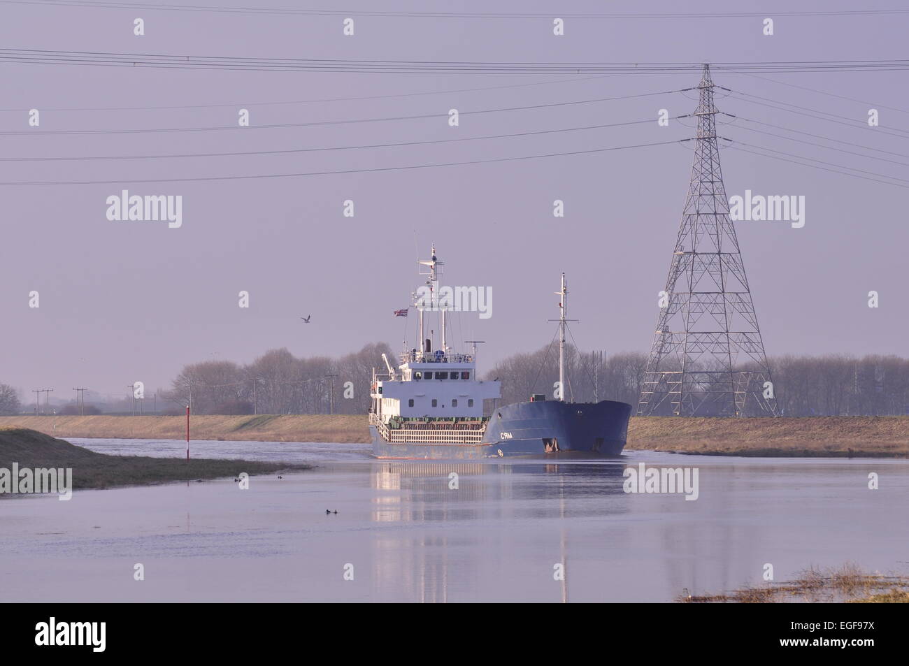 The Russian registered cargo ship Syam moving seawards down the River Nene, Lincolnshire from the port of Wisbech UK Stock Photo