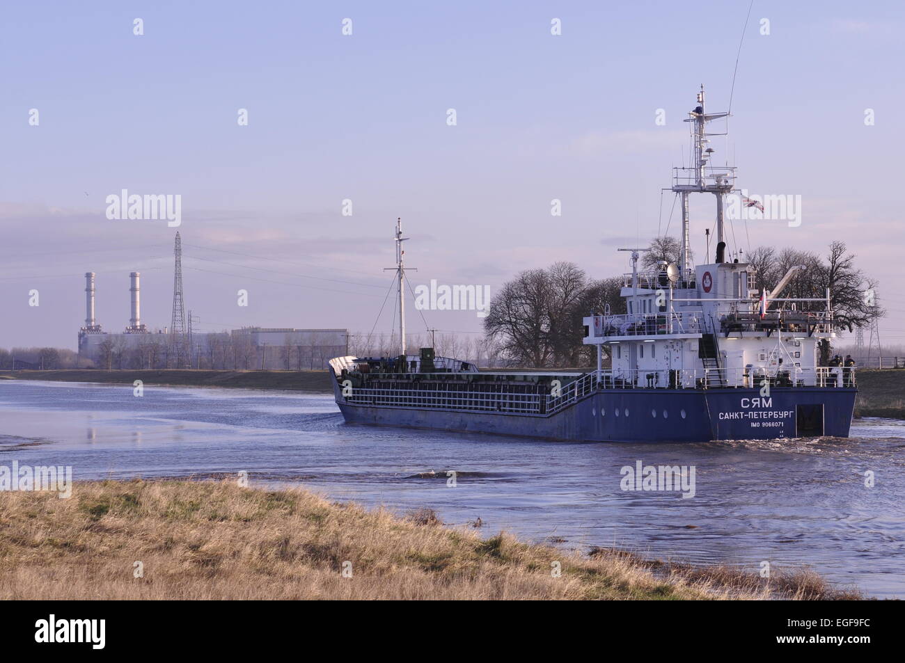 The Russian registered cargo ship Syam moving seawards down the River Nene, Lincolnshire from the port of Wisbech UK Stock Photo