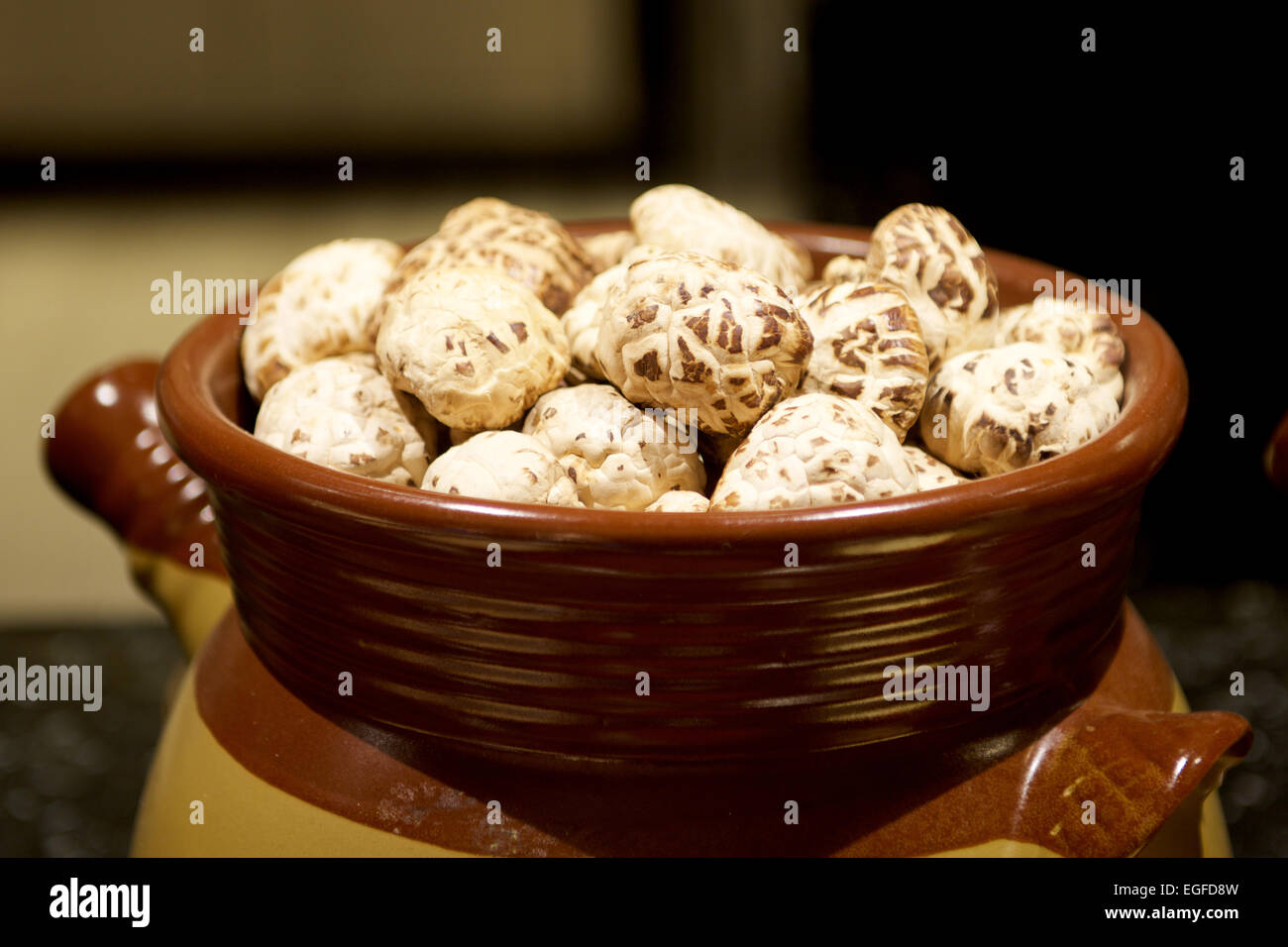 White Shiitake Chinese Mushrooms in a traditional container Stock Photo