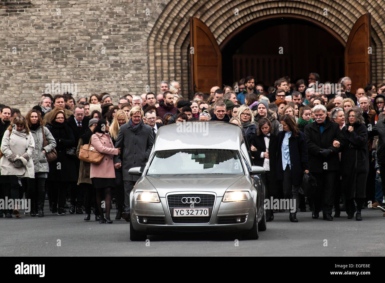 Copenhagen, Denmark. 24th February, 2015. Film director, Finn Norgaard is buried today. Here the guests are gathered at the hearse after the ceremony in Grundvigskirken, Copenhagen. Some 800 attended the funeral. Among these also PM Helle Thorning-Schmidt Credit:  OJPHOTOS/Alamy Live News Stock Photo