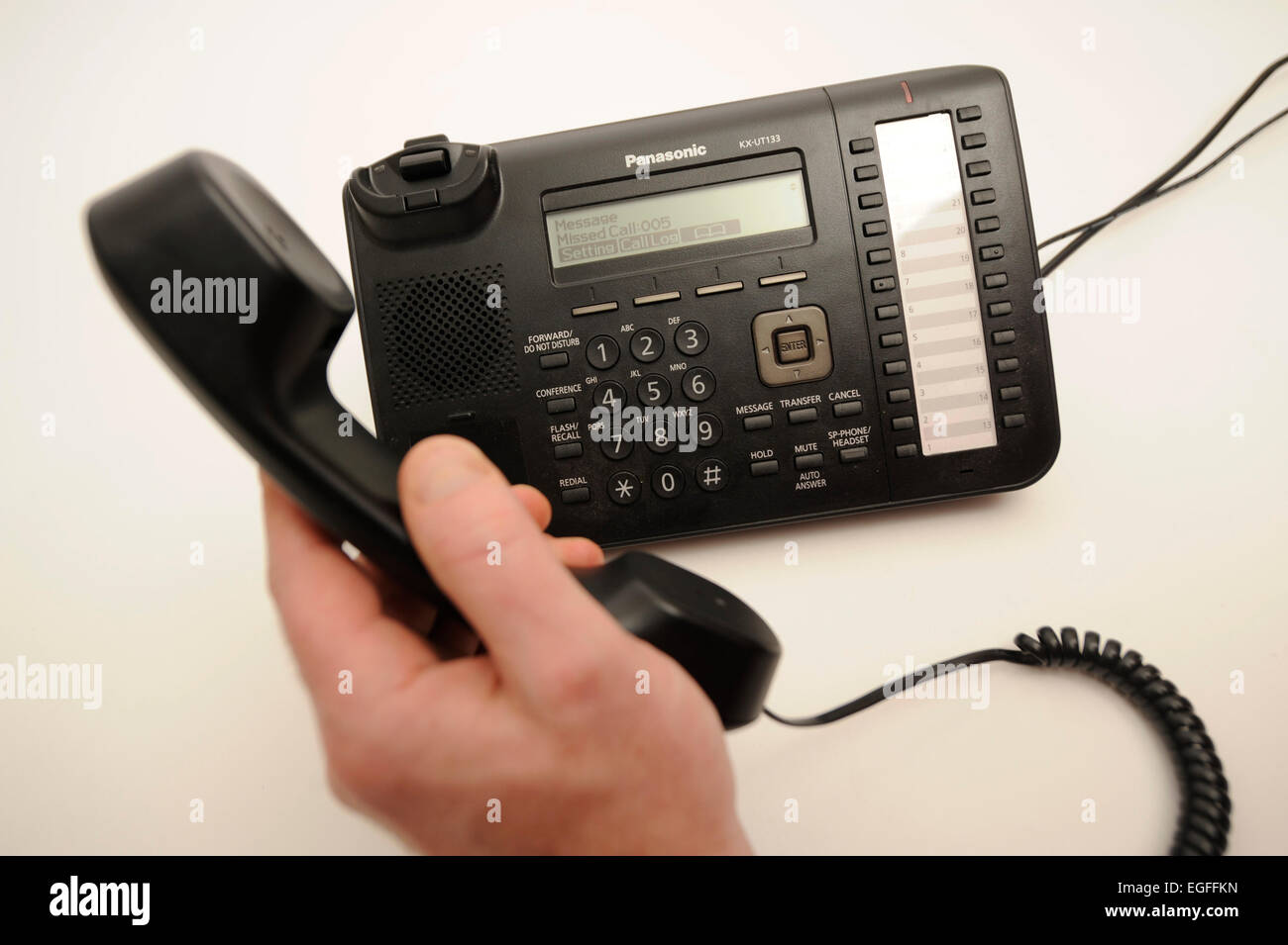 Picking up a Office Phone Stock Photo