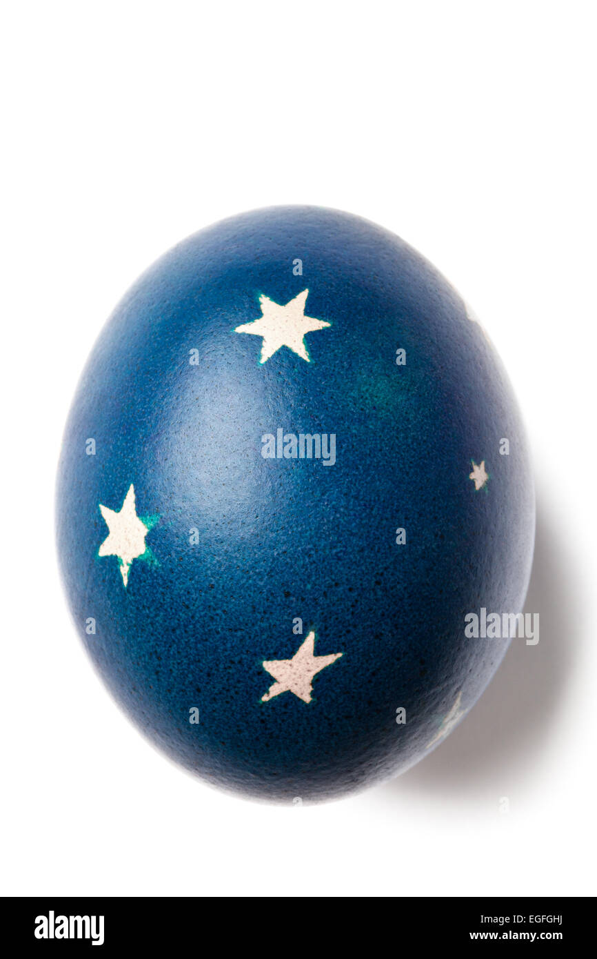 Blue painted Easter egg with decorations isolated on white. Stock Photo
