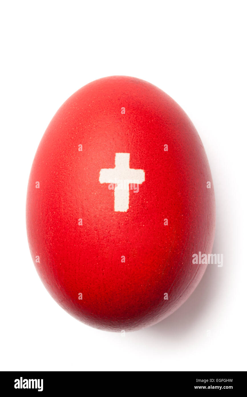 Red painted Easter egg with white cross on it isolated on white. Image with working path. Stock Photo