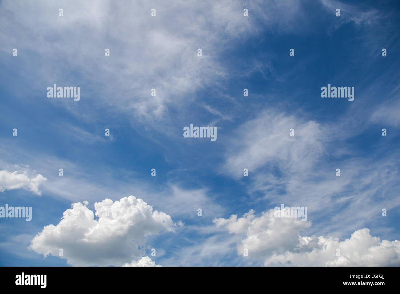 White cirrus and cumulus clouds on a sunny blue sky Stock Photo - Alamy
