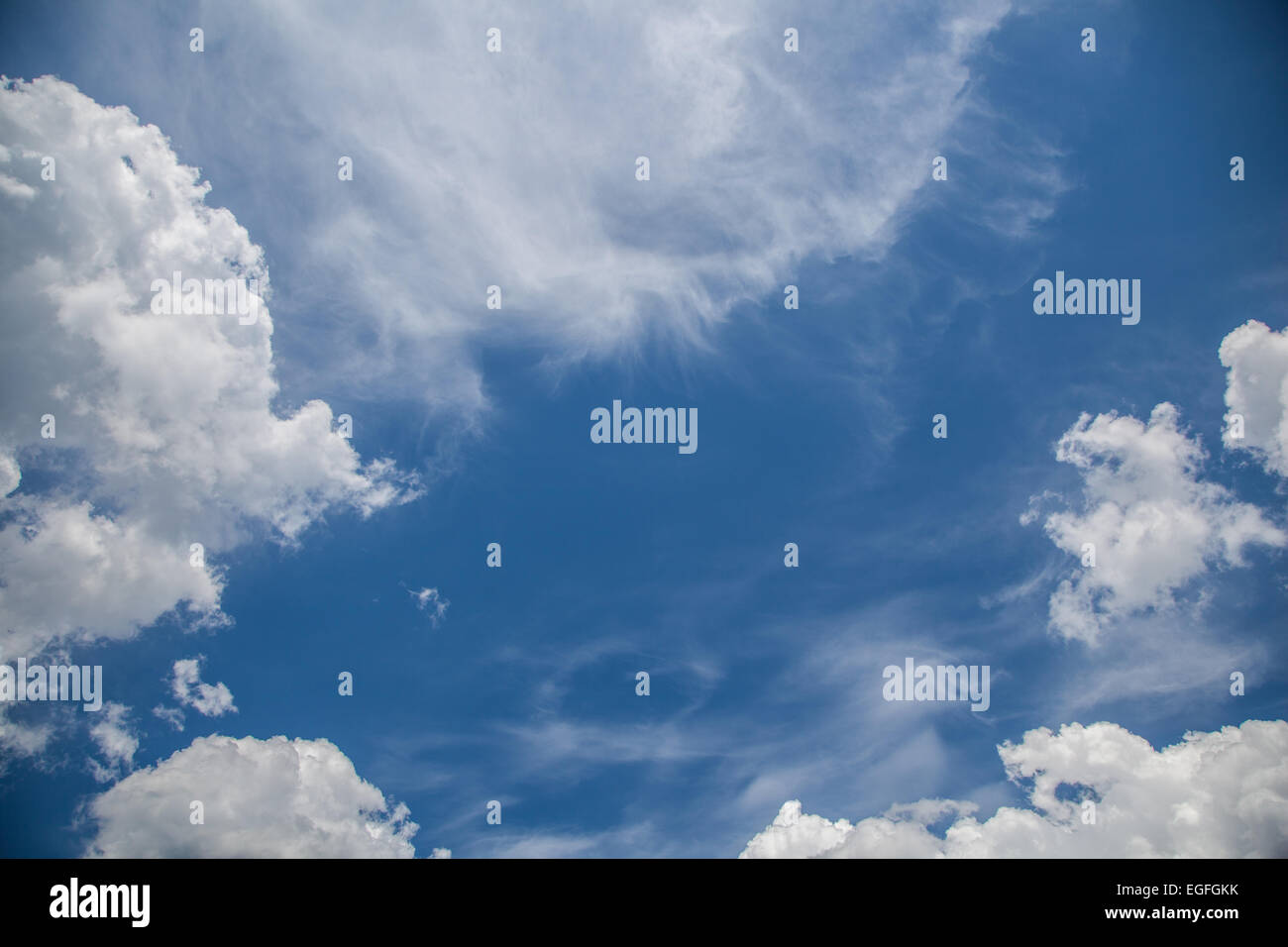 White cirrus and cumulus clouds on a sunny blue sky Stock Photo - Alamy