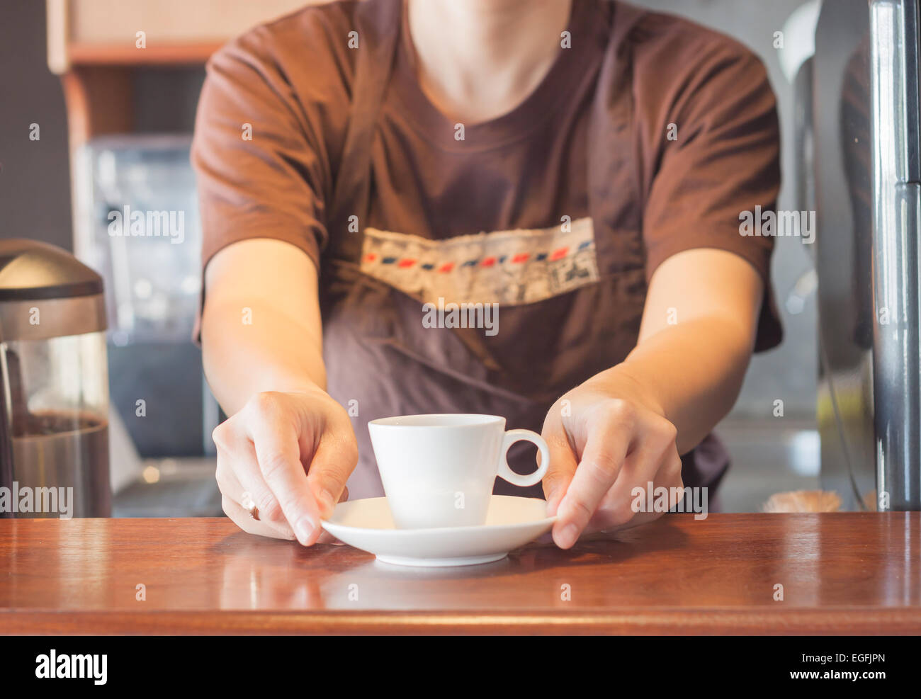Barista offering mini white cup of coffee, stock photo Stock Photo