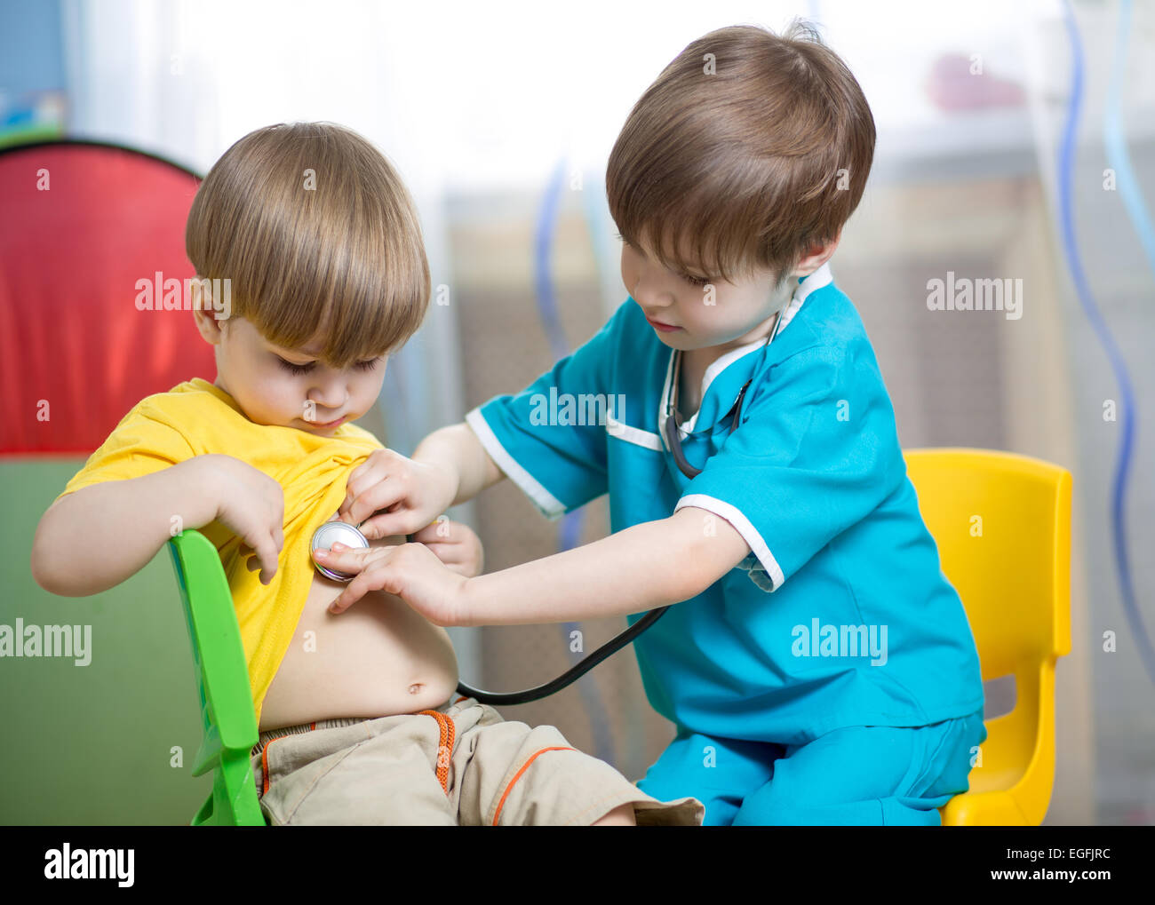 children boys play doctor at home Stock Photo