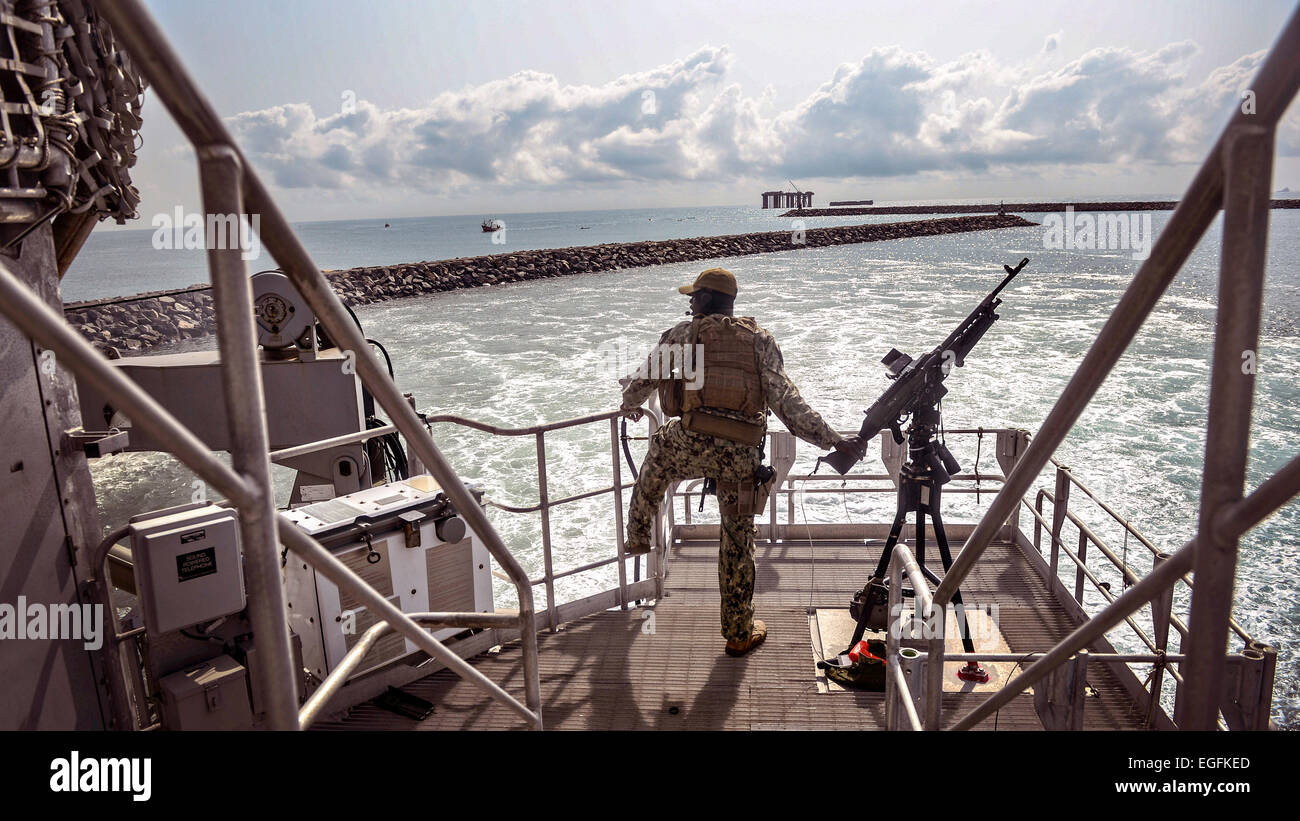 A US sailor stands guard as the Military Sealift Command's Joint High-speed Vessel USNS Spearhead pulls into harbor as part of Africa Maritime Law Enforcement Partnership February 14, 2015 in Sekondi, Ghana. Stock Photo