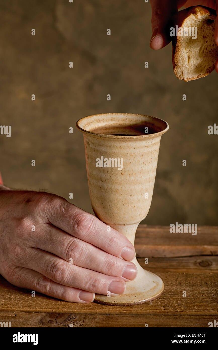 chalice of wine and bread on the dark background Stock Photo
