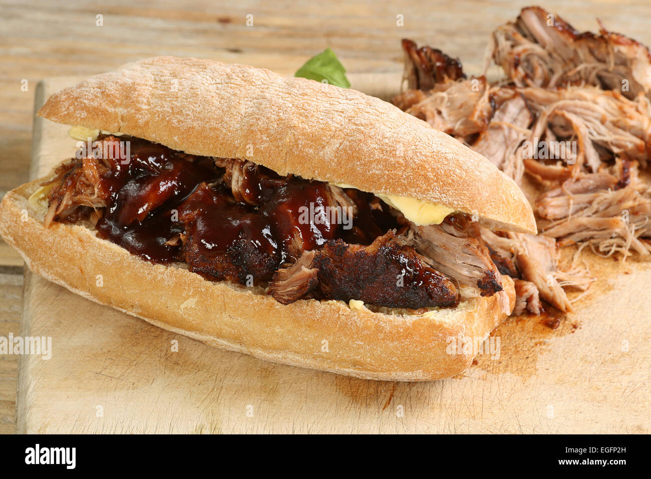 pulled pork with barbecue sauce on a crusty bread roll Stock Photo Alamy