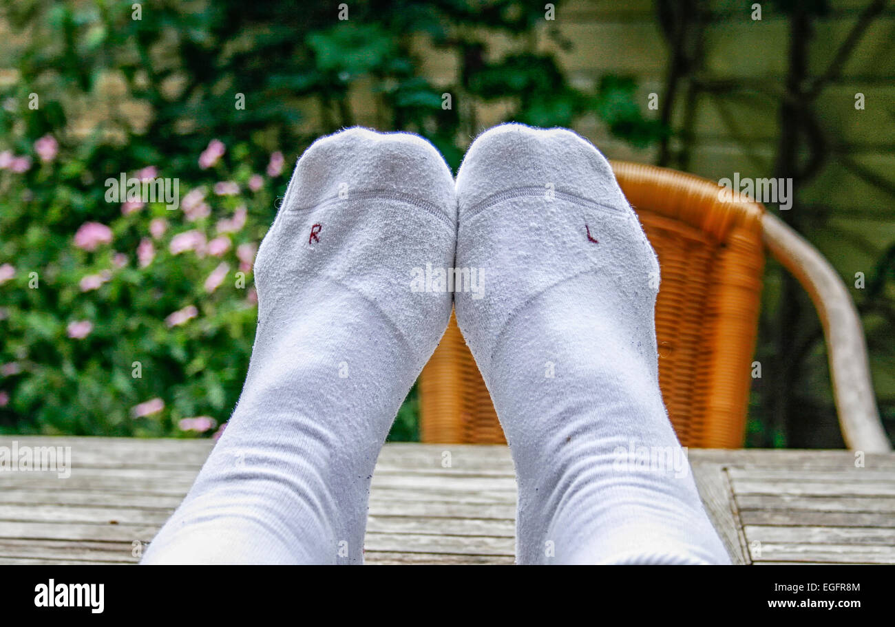 Wearing left sock on right foot and right sock on left foot Stock Photo Alamy