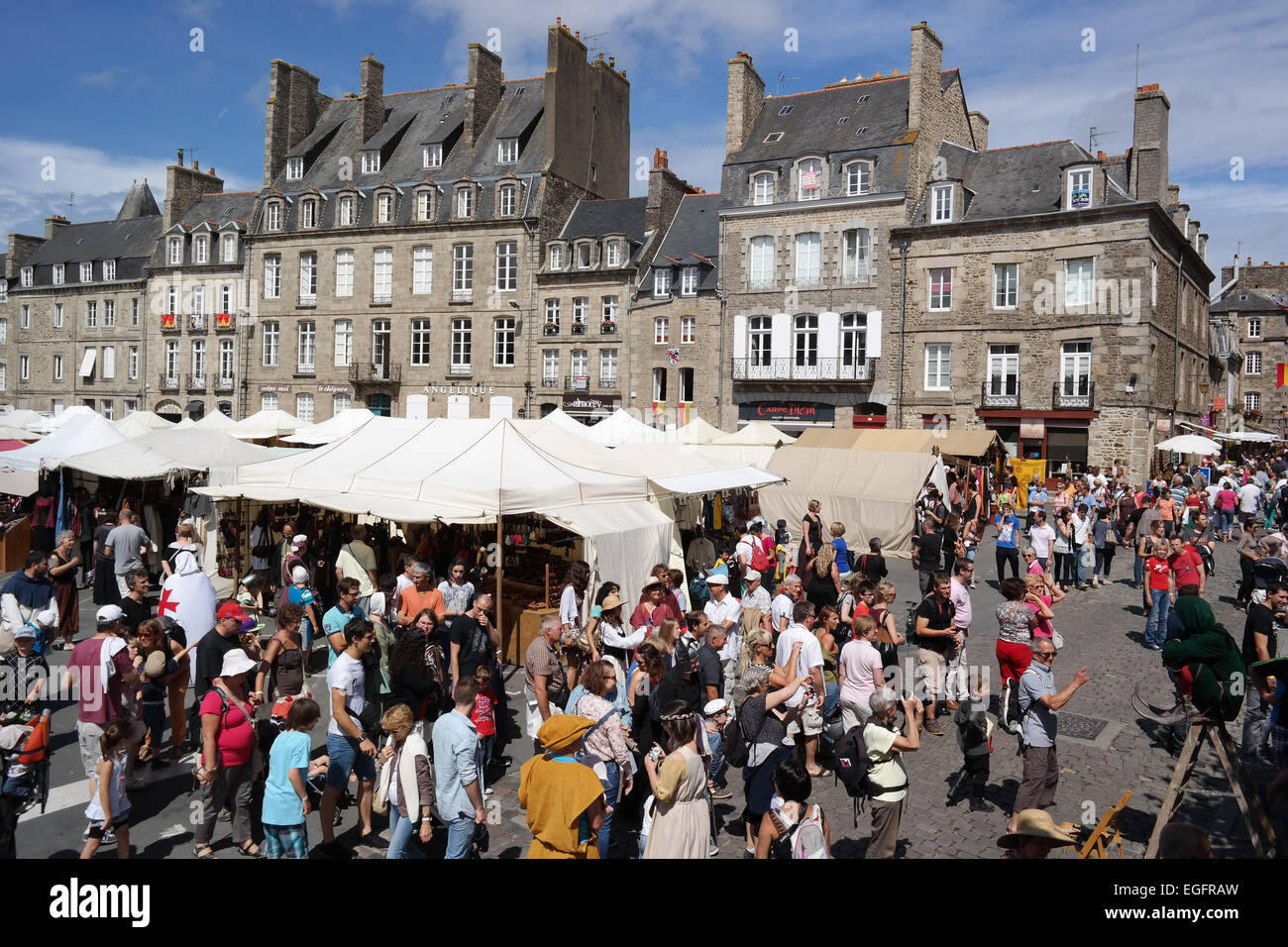 DINAN, FRANCE - JULY 2014:  Many of crowd people dressed up in a medieval costume on a popular Knights Festival Stock Photo