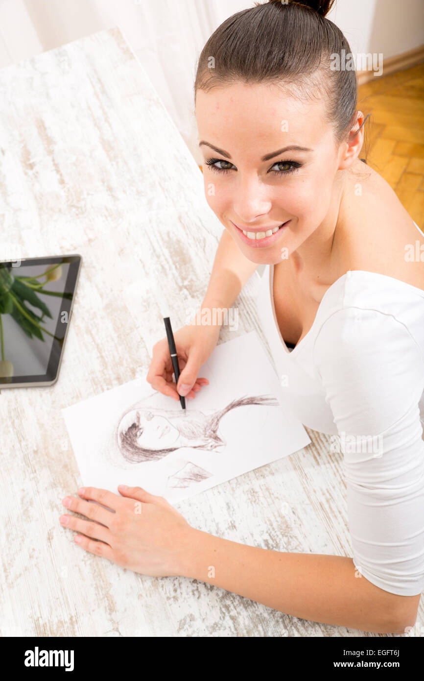 A young fashion designer working with a tablet pc Stock Photo - Alamy