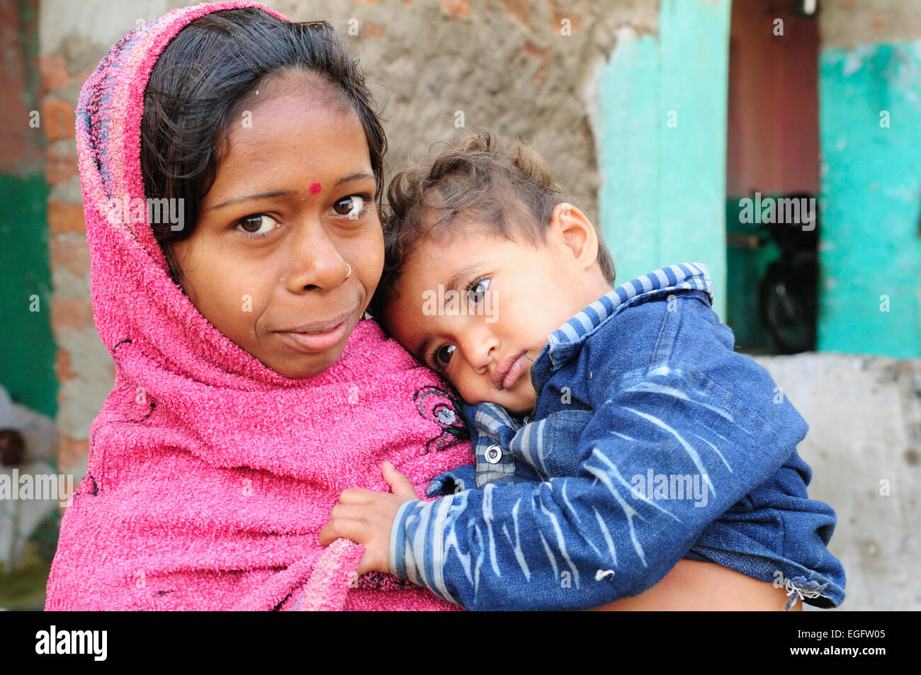 An Indian baby little boy in his mothers arms in an Indian village Madhya Pradesh India Stock Photo
