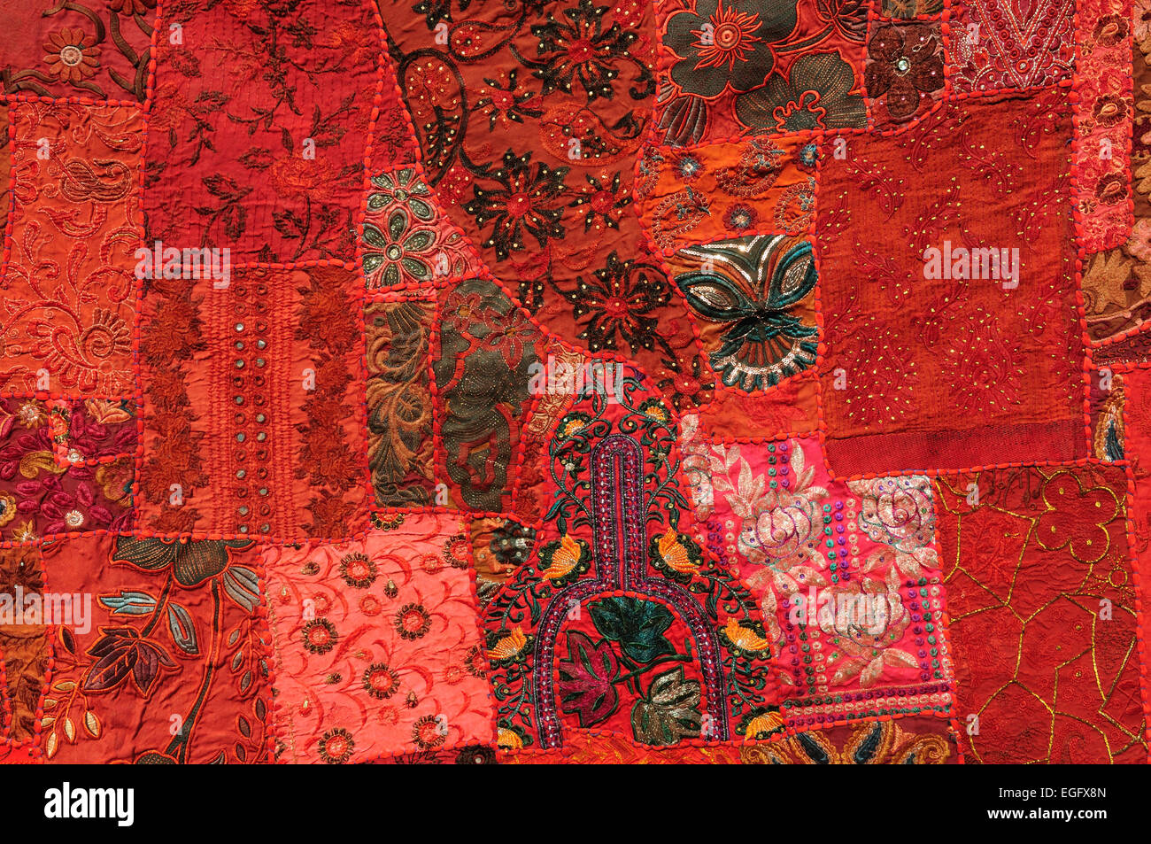 Close up of bright red wall hanging made up from old saris Madhya Pradesh India Stock Photo