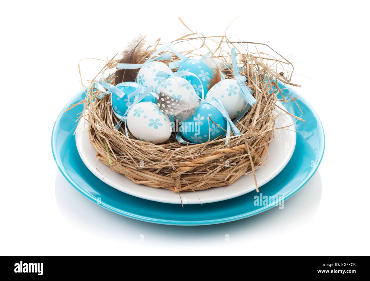 Easter eggs nest on plate. Isolated on white background Stock Photo - Alamy