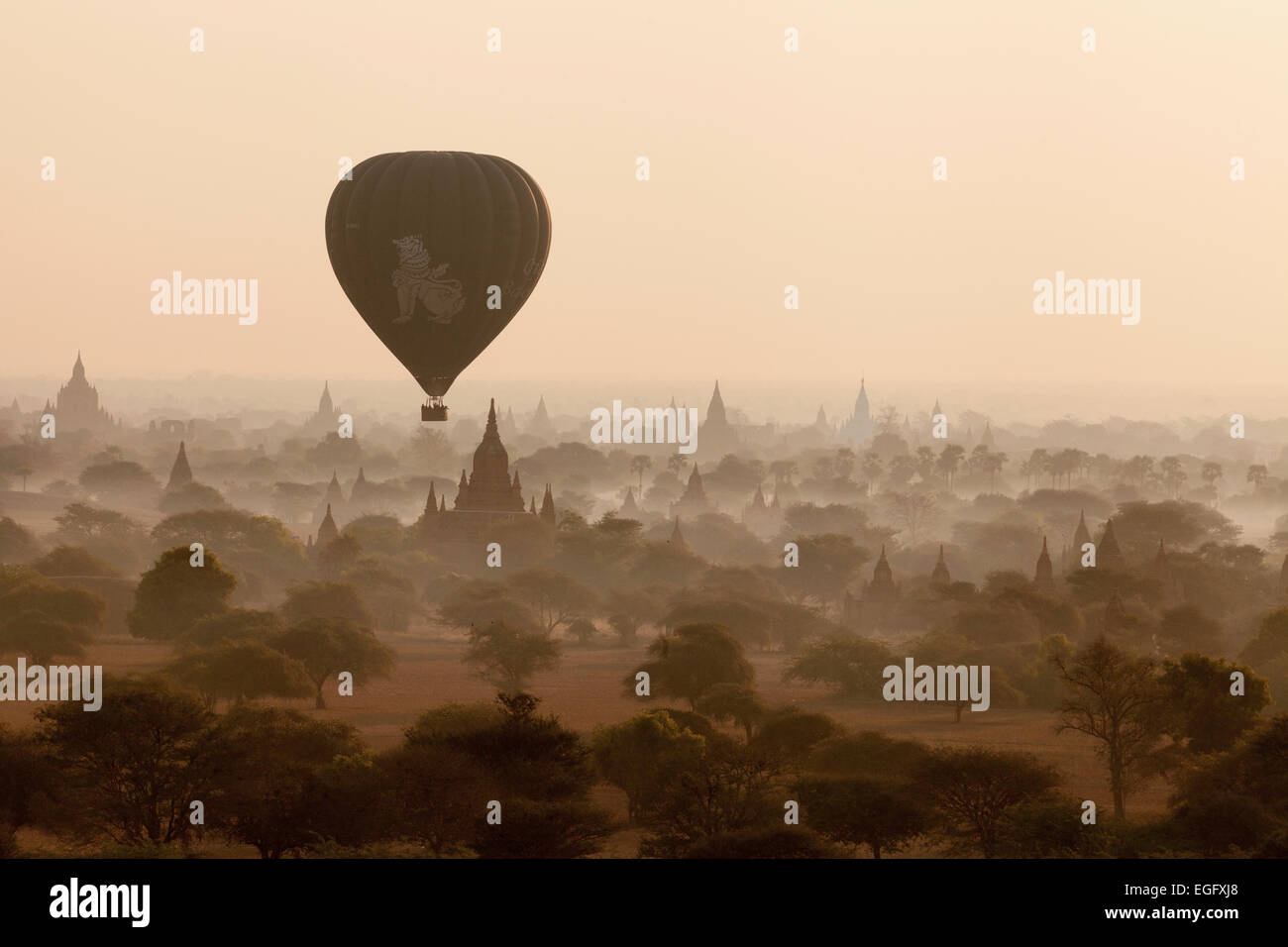 A hot air balloon over Bagan temples, stupas and pagodas at sunrise, Bagan, Myanmar ( Burma ), Asia Stock Photo