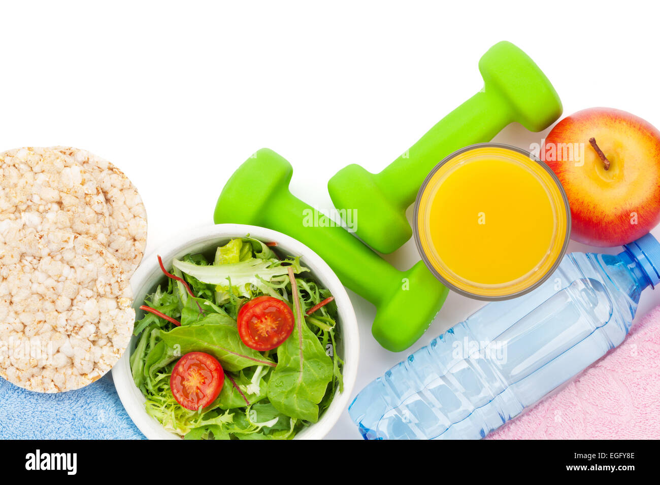 Dumbells, healthy food and towels. Fitness and health. Isolated on white background Stock Photo