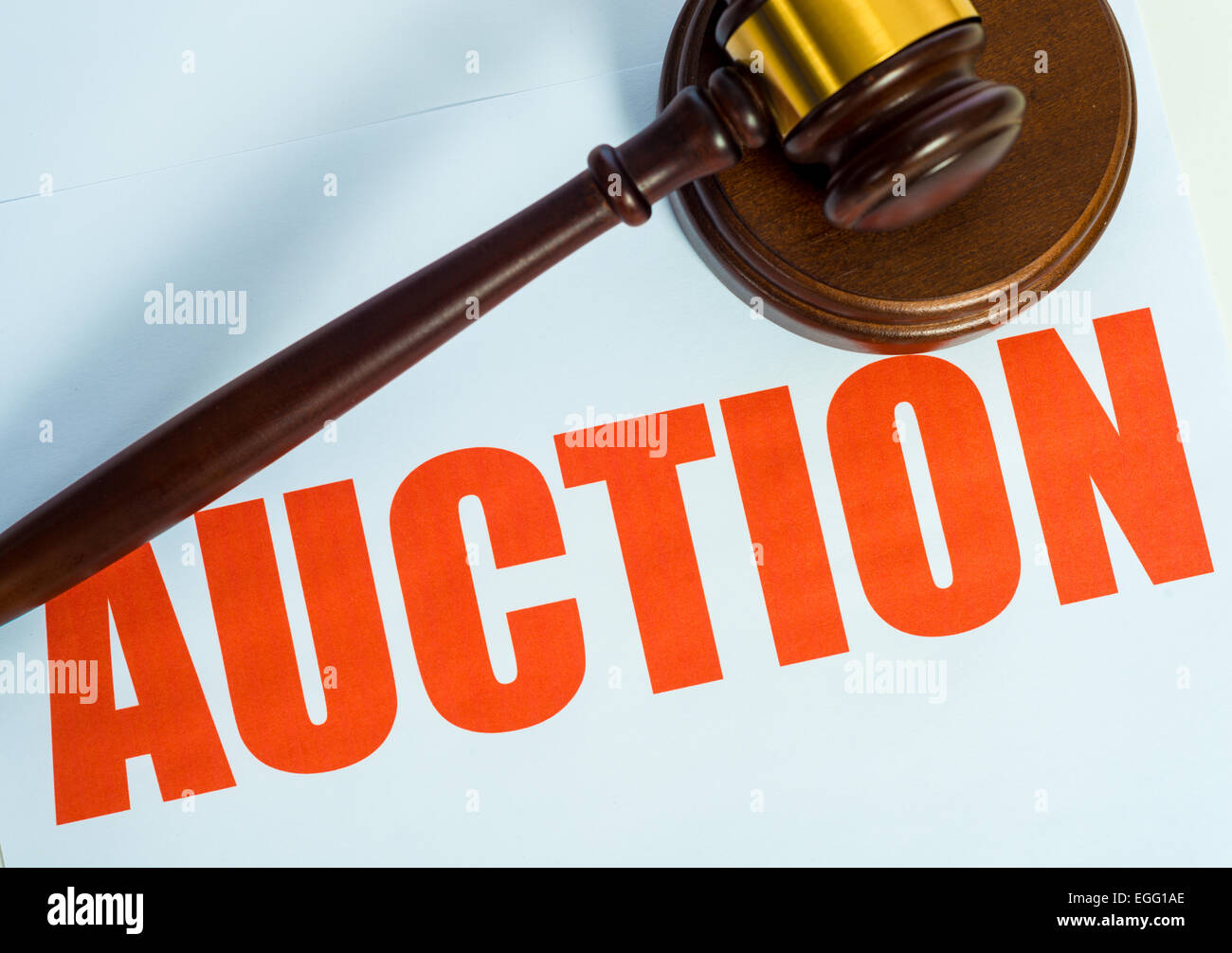 An auction sign and wooden mallet on a white background Stock Photo