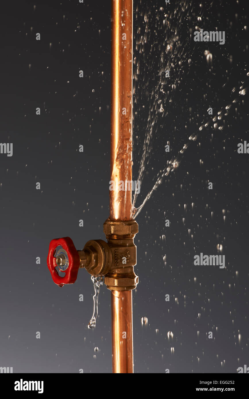 Plumbing burst Leaking Pipe with Tap Stock Photo